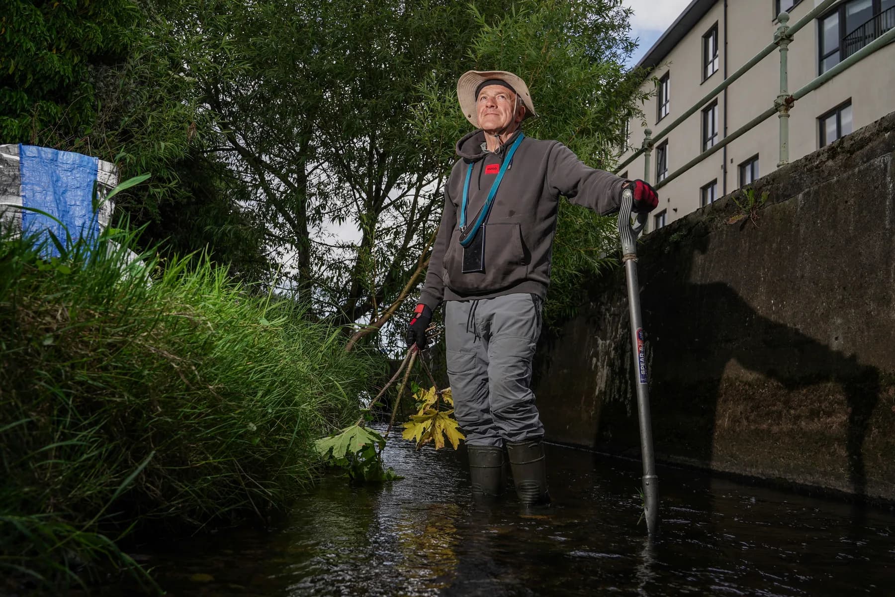 Local litter-pick celebrity Adrian Laird Craig holds an invasive Hogweed plant by the banks of the Water of Lieth. These plants overrun the native species on the river bank and are poisonous to humans. Now retired, Craig spends his days cleaning out the massive weeds himself.